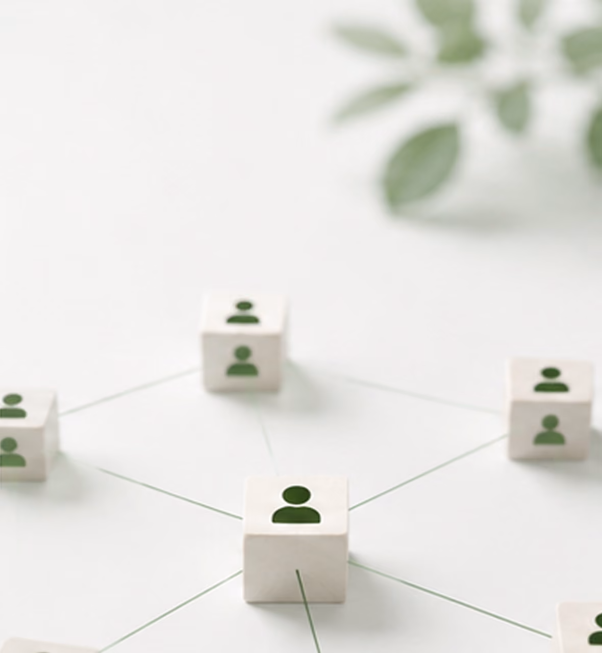 Wooden blocks with user icons linked by lines showing a connected network on a white surface.